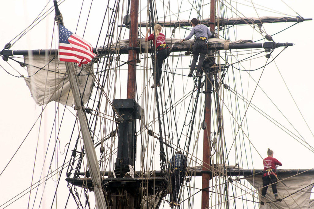 Deckhands prepare the sails on Lady Washington historic “tall ship” in Langley’s harbor. (Wendy Leigh / South Whidbey Record)
