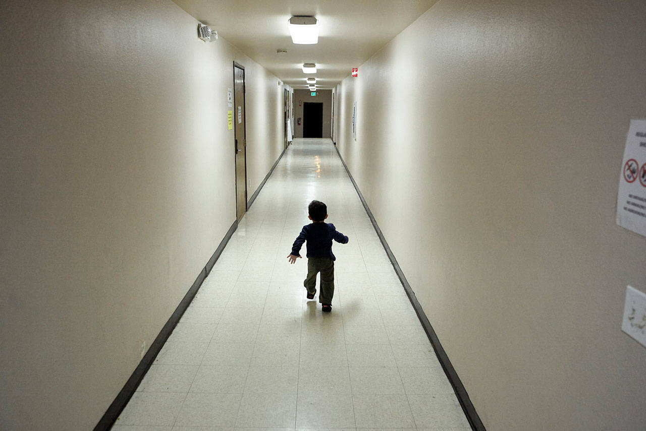 In this Dec. 11, 2018, file photo, an asylum-seeking boy from Central America runs down a hallway after arriving from an immigration detention center to a shelter in San Diego. The Trump administration will make a case in court to end a longstanding settlement governing detention conditions for immigrant children, including how long they can be held by the government. A hearing is scheduled before a federal judge Friday In Los Angeles over the so-called Flores settlement. (AP Photo/Gregory Bull, File)
