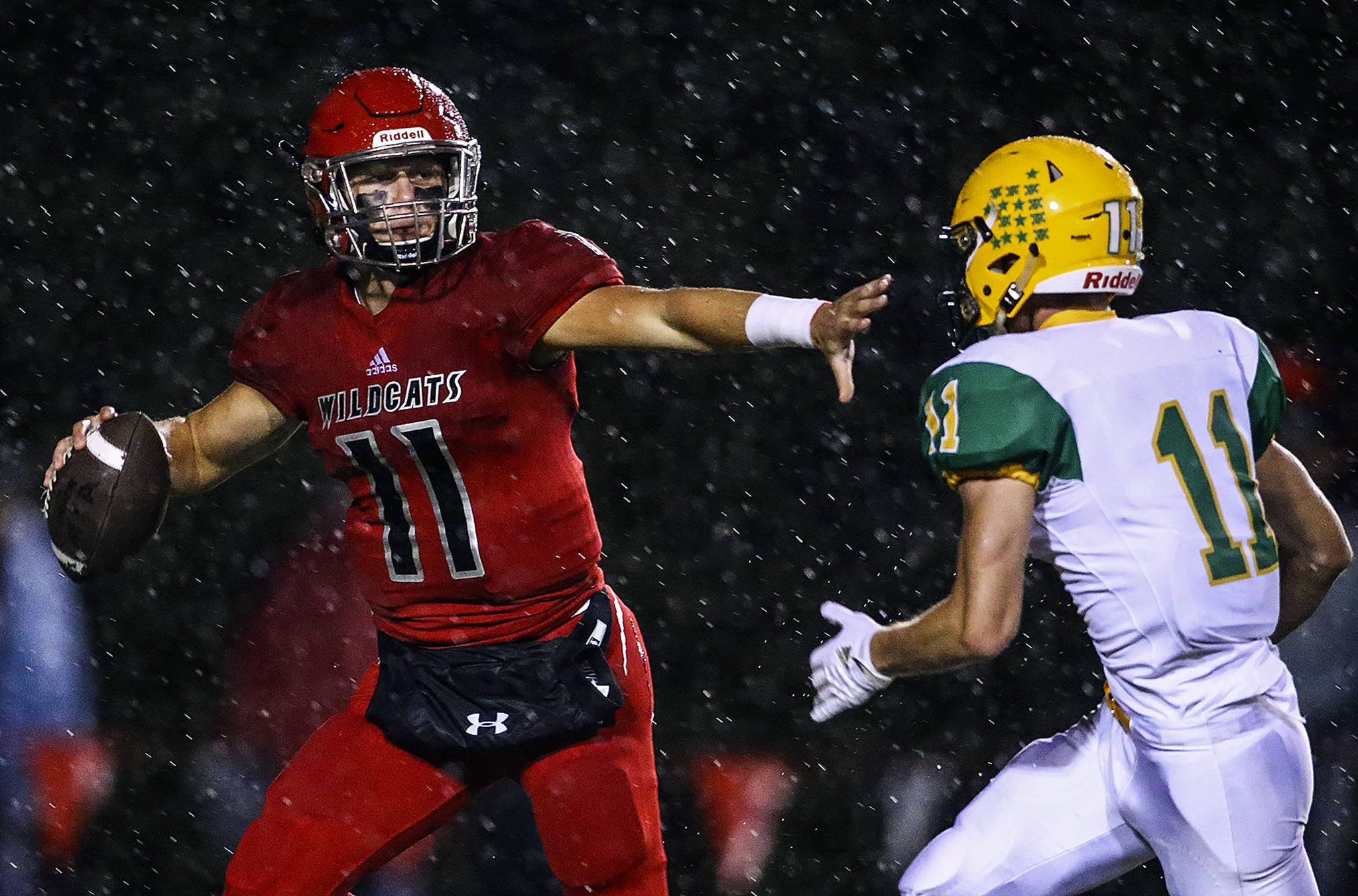 Archbishop Murphy’s Victor Gabalis is chased out of the pocket by Lynden’s Elijah Lyons in the first quarter of a game on Sept. 27, 2019, at Archbishop Murphy High School in Everett. (Kevin Clark / The Herald)