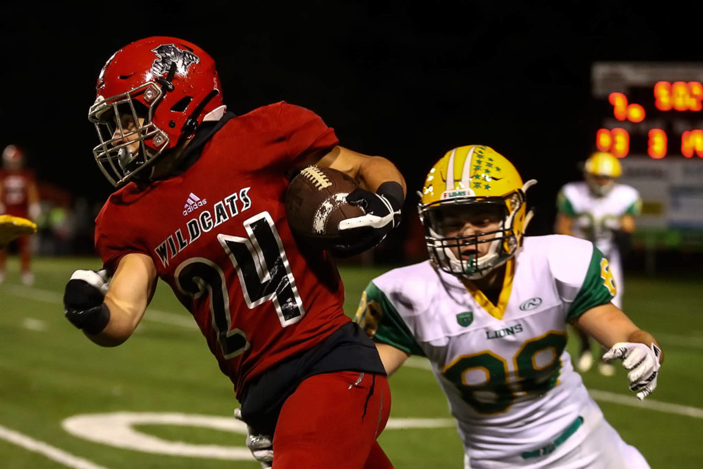 Archbishop Murphy’s Joe Ennis runs up the sideline with Lynden’s Lukas Lohrer trailing during a game on Sept. 27, 2019, at Archbishop Murphy High School in Everett. (Kevin Clark / The Herald)
