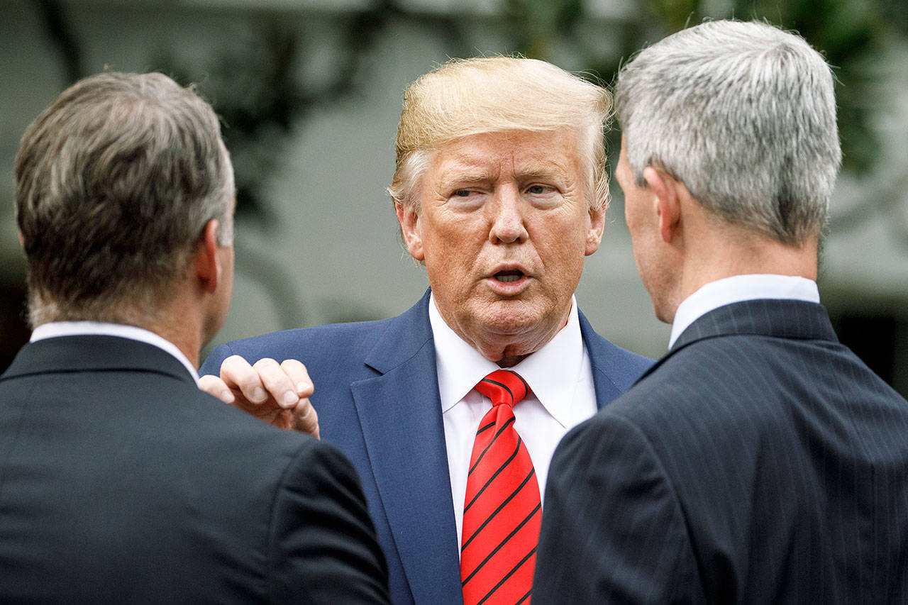 President Donald Trump pauses Thursday to talk as he leaves a ceremony with members of law enforcement on the South Lawn of the White House. The president was given a plaque of appreciation from America’s Sheriffs and Angel Families. (AP Photo/Carolyn Kaster)