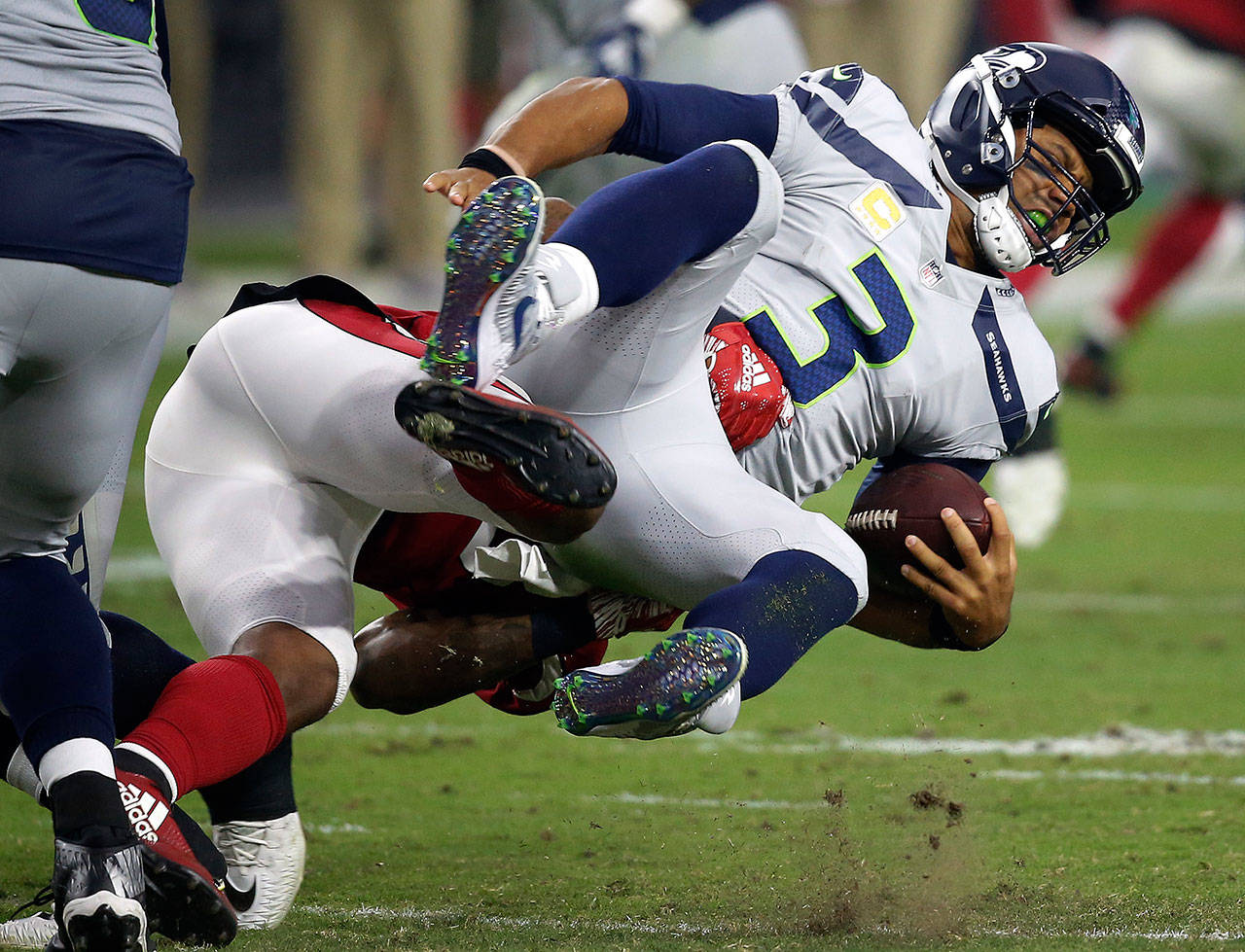Seahawks quarterback Russell Wilson (3) is sacked by Cardinals linebacker Haason Reddick during the first half of a game Sept. 30, 2018, in Glendale, Ariz. (AP Photo/Ross D. Franklin)
