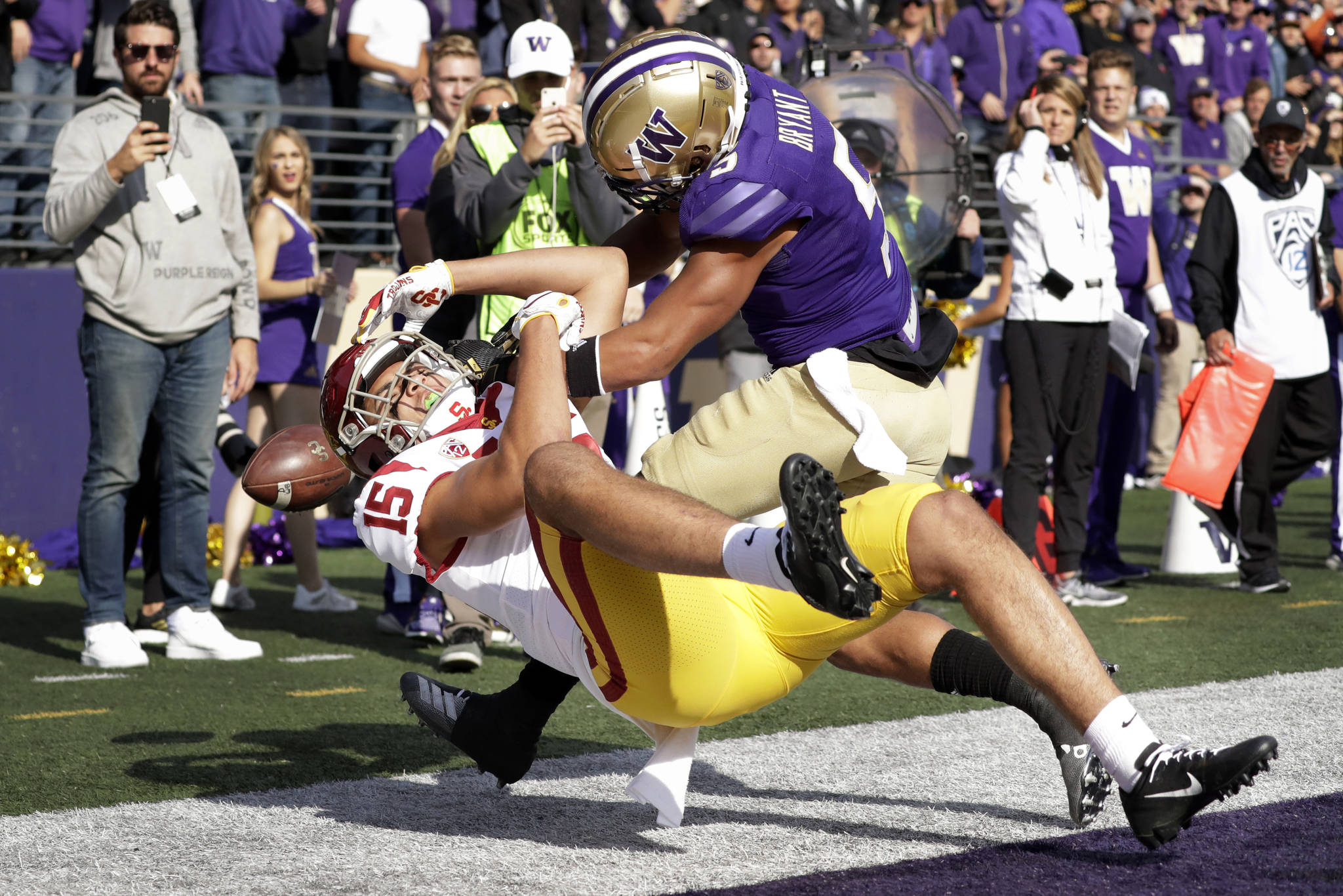Washington defensive back Myles Bryant (right) breaks up a pass in the end zone during the fourth quarter of the Huskies’ 28-14 win over USC on Saturday at Husky Stadium. (Elaine Thompson / Associated Press)
