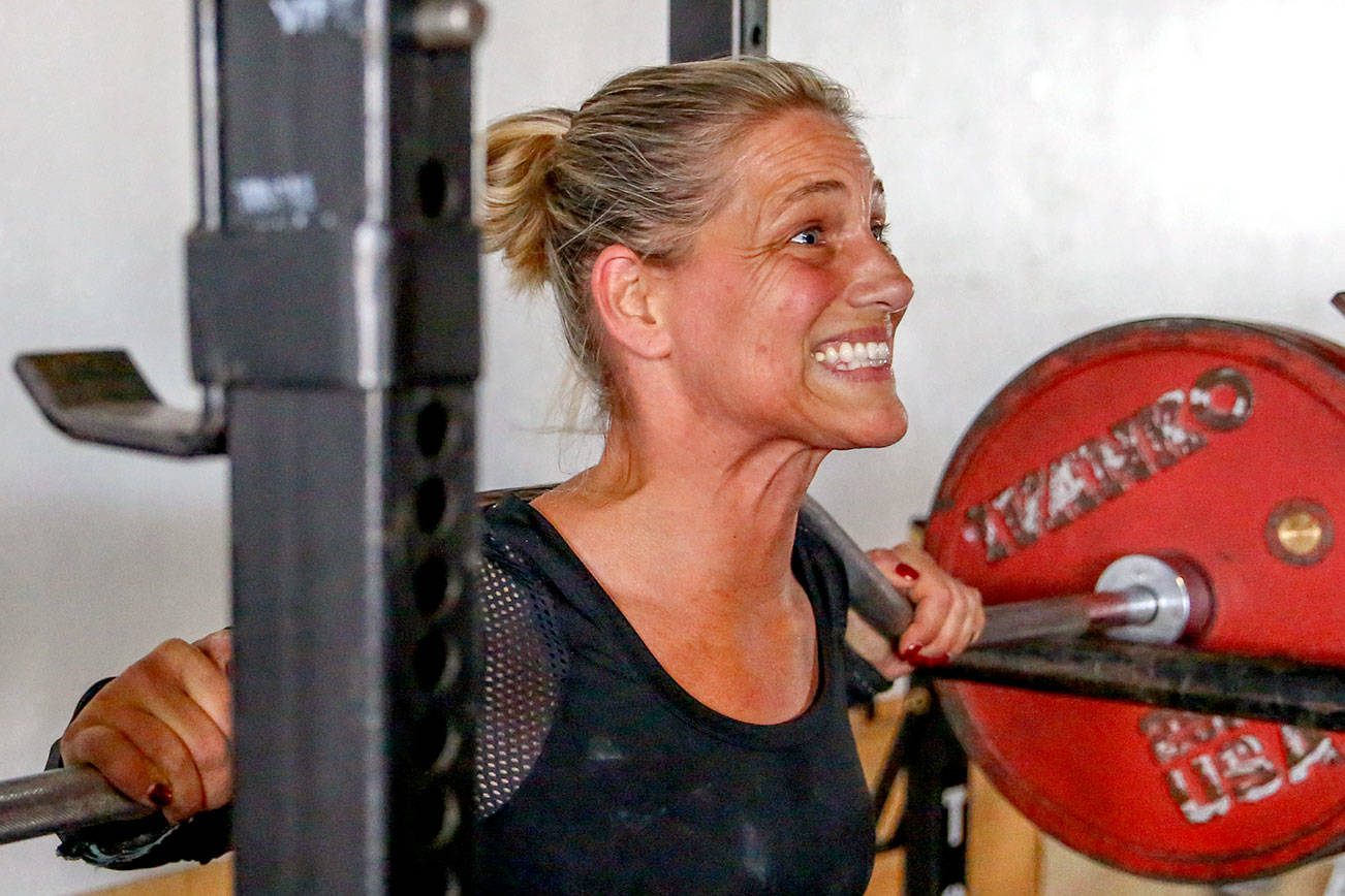 Colleen Hansford works through squats Tuesday evening at EGO Strength and Performance in Everett on September 24, 2019. (Kevin Clark / The Herald)