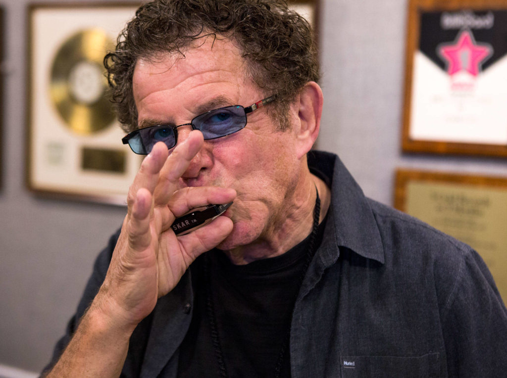 Lee Oskar plays his harmonica at his home in Everett. (Olivia Vanni / The Herald)
