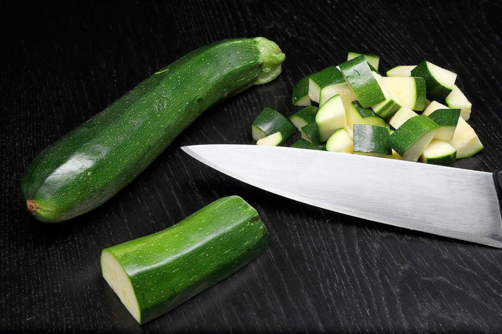 Making ratatouille is a great way to work on your knife skills. For the zucchini, slice into half moons or dice it, as shown here. (Terrence Antonio James/Chicago Tribune)
