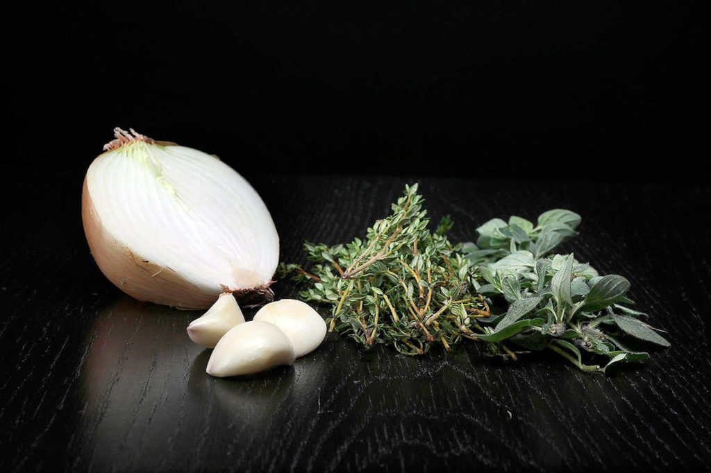 Aromatics (onions, garlic and herbs) flavor all of those vegetables. (Terrence Antonio James/Chicago Tribune)
