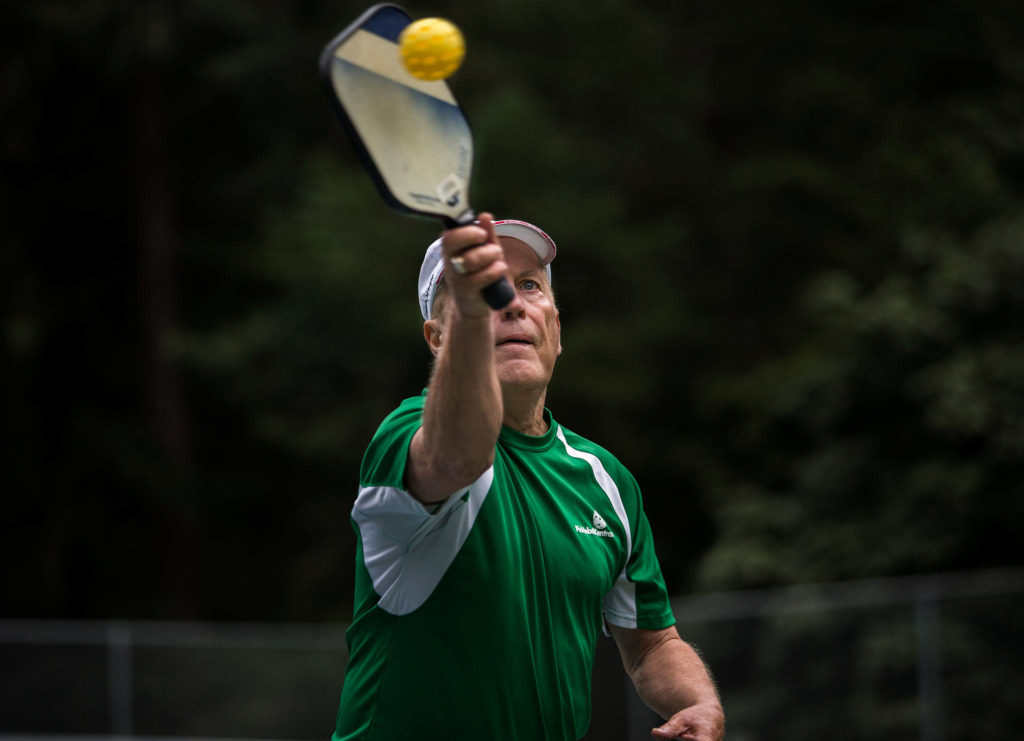 Roger BelAir hits the ball during a friendly game of pickleball at Yost Park in Edmonds. (Olivia Vanni / The Herald)
