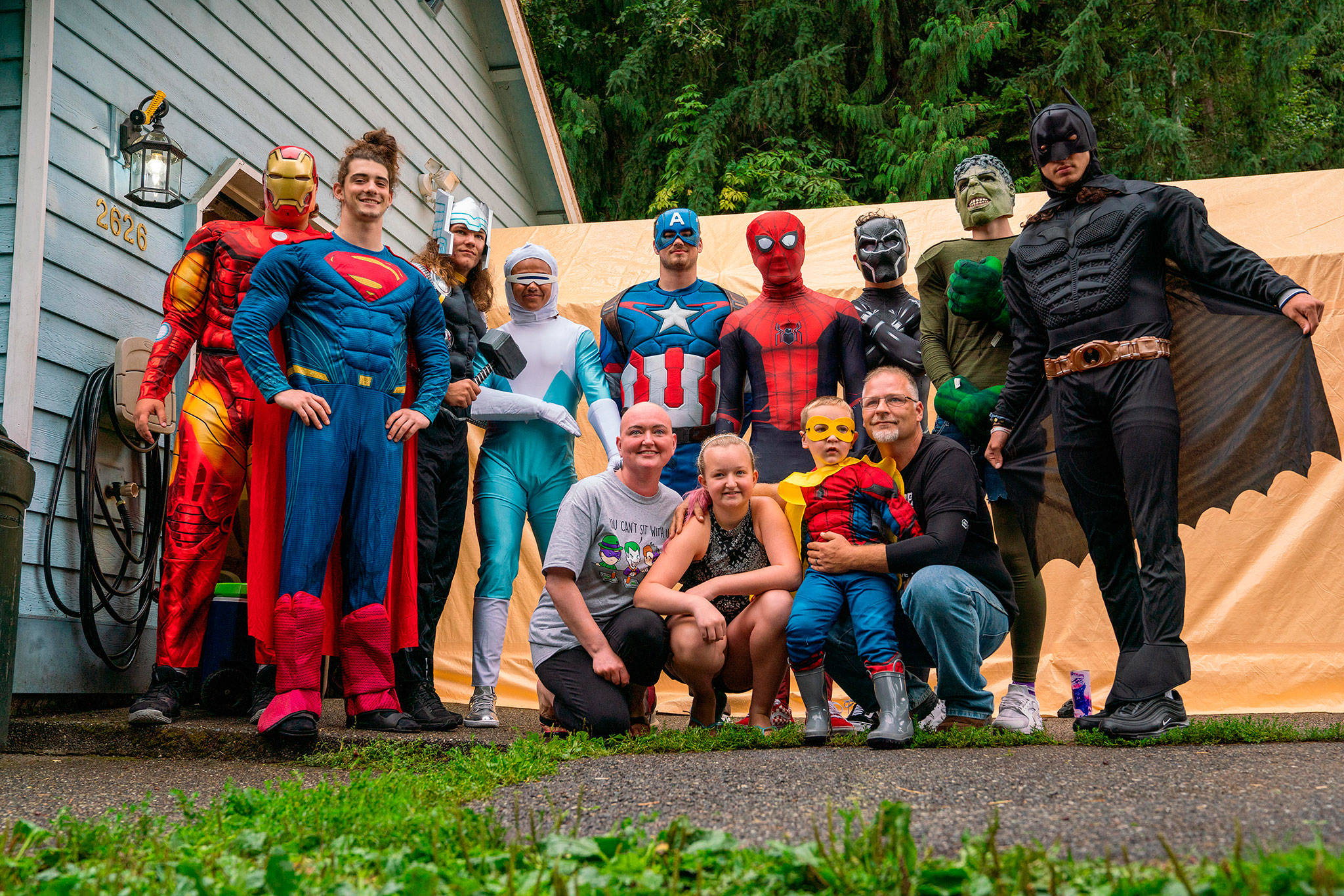 Lake Stevens football players dressed in superhero costumes and surprised local boy Grayson Wright for his fourth birthday party last month. Wrights family has gone through a tough time after his mother, Aliciasue, was diagnosed with a rare form of cancer this summer. (Rio Vitale)