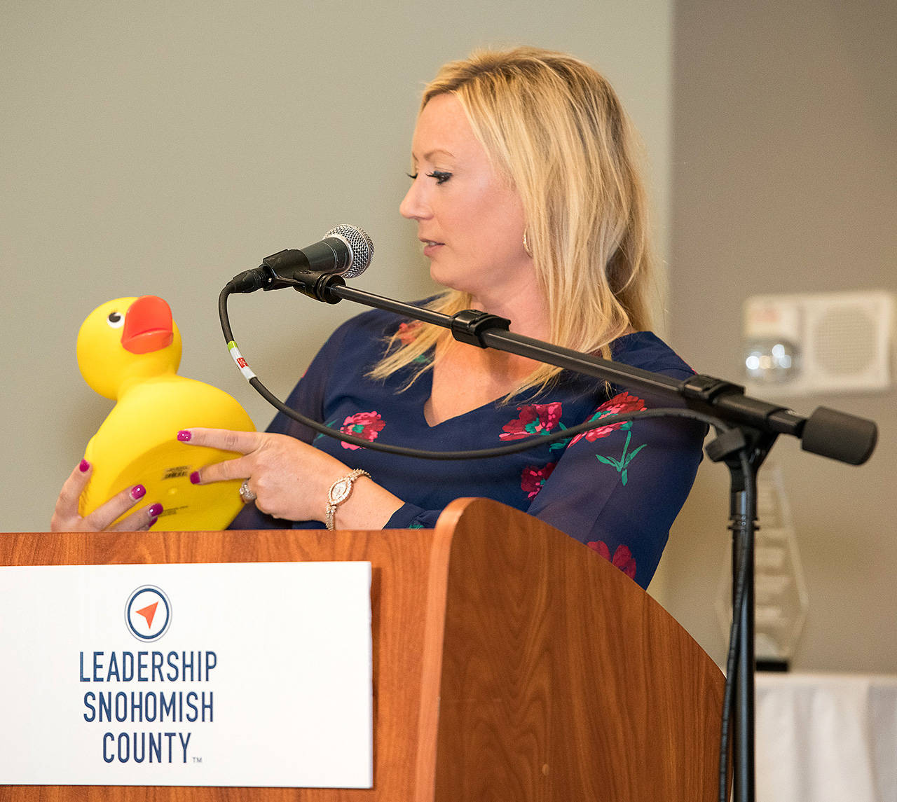 Lisa Lefeber examines the rubber ducky that was a humorous stand-in for her award from Leadership Snohomish County. The real awards were lost in transit.. (Photo by Jay Dotson)