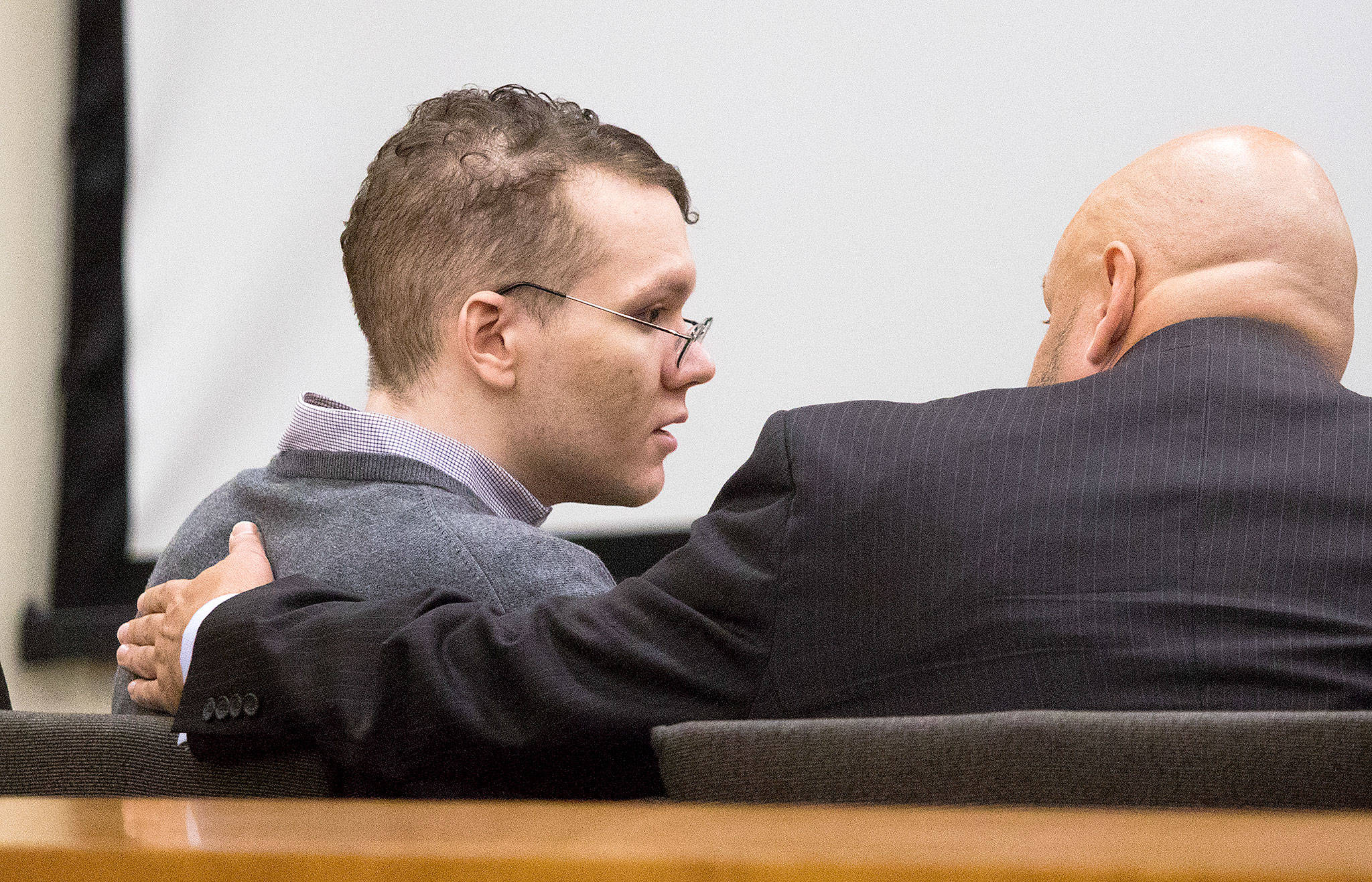 Defendant Anthony Garver listens to his defense attorney Jon Scott before pretrial motions on Tuesday in Everett. (Andy Bronson / The Herald)