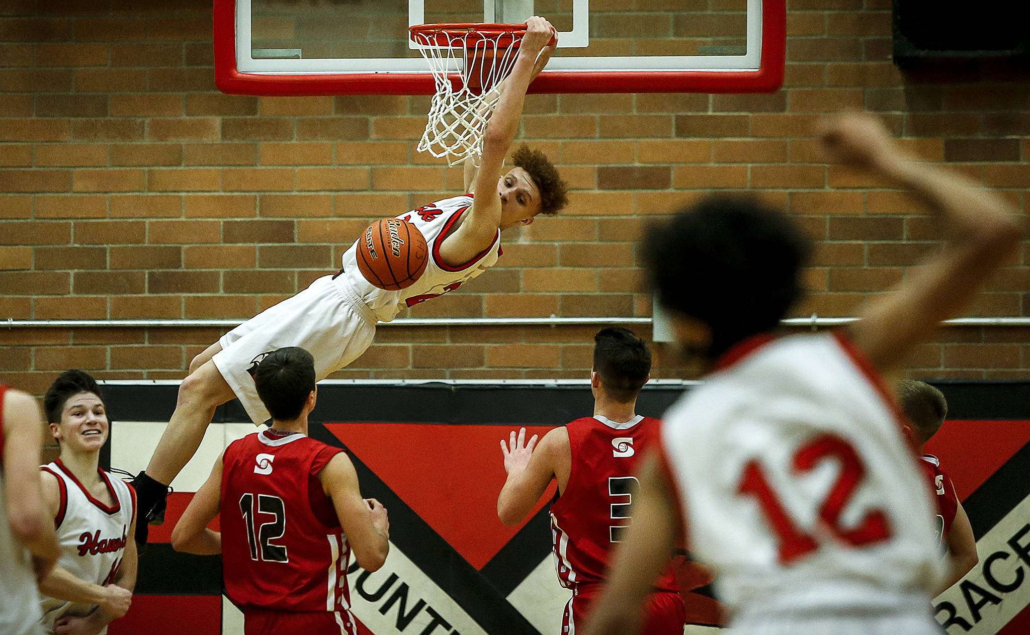 Mountlake Terrace’s Khyree Amrstead (center) throws down a dunk during a decisive victory over Stanwood at Mountlake Terrace High School on Jan. 30, 2018. (Ian Terry / Herald file)
