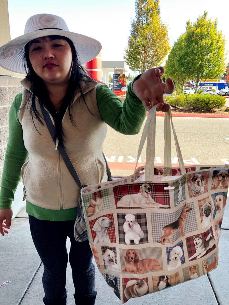 Kim Phuong brought her “doggy bag” to grocery shop Monday at an Everett grocery store. (Janice Podsada / The Herald)

