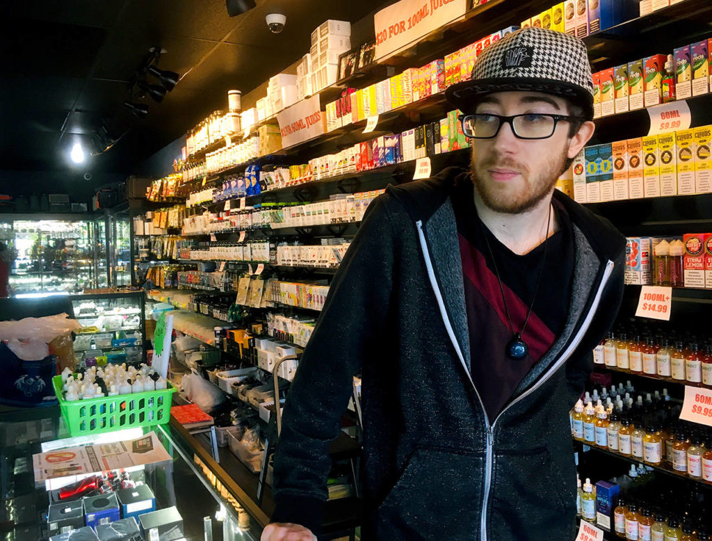 Employee Marcus Esmay talks about the proposed ban on vape flavors at the store he works at in Everett. (Sue Misao / The Herald) 
