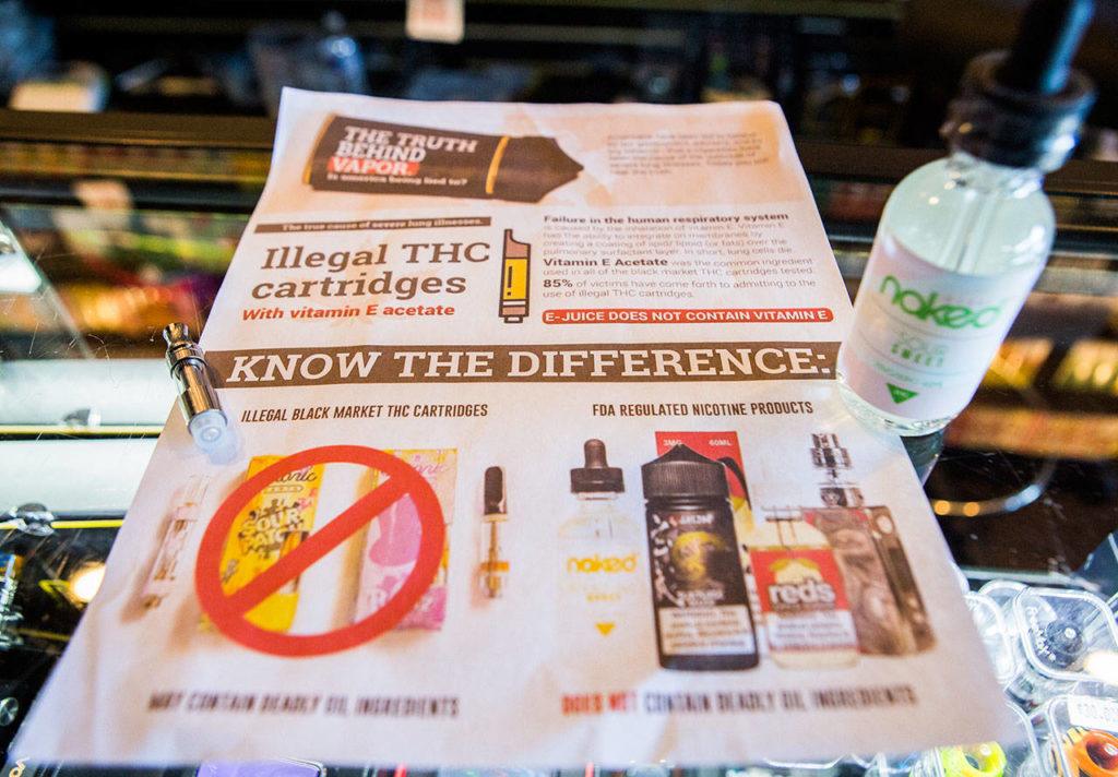 A flyer referencing information related to the recent vape legislation sits on the counter of a store in Everett. (Olivia Vanni / The Herald)
