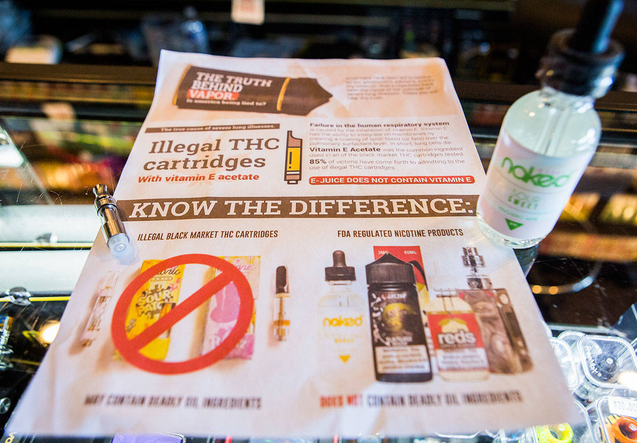 A flyer referencing information related to the recent vape legislation sits on the counter of a store in Everett. (Olivia Vanni / The Herald)