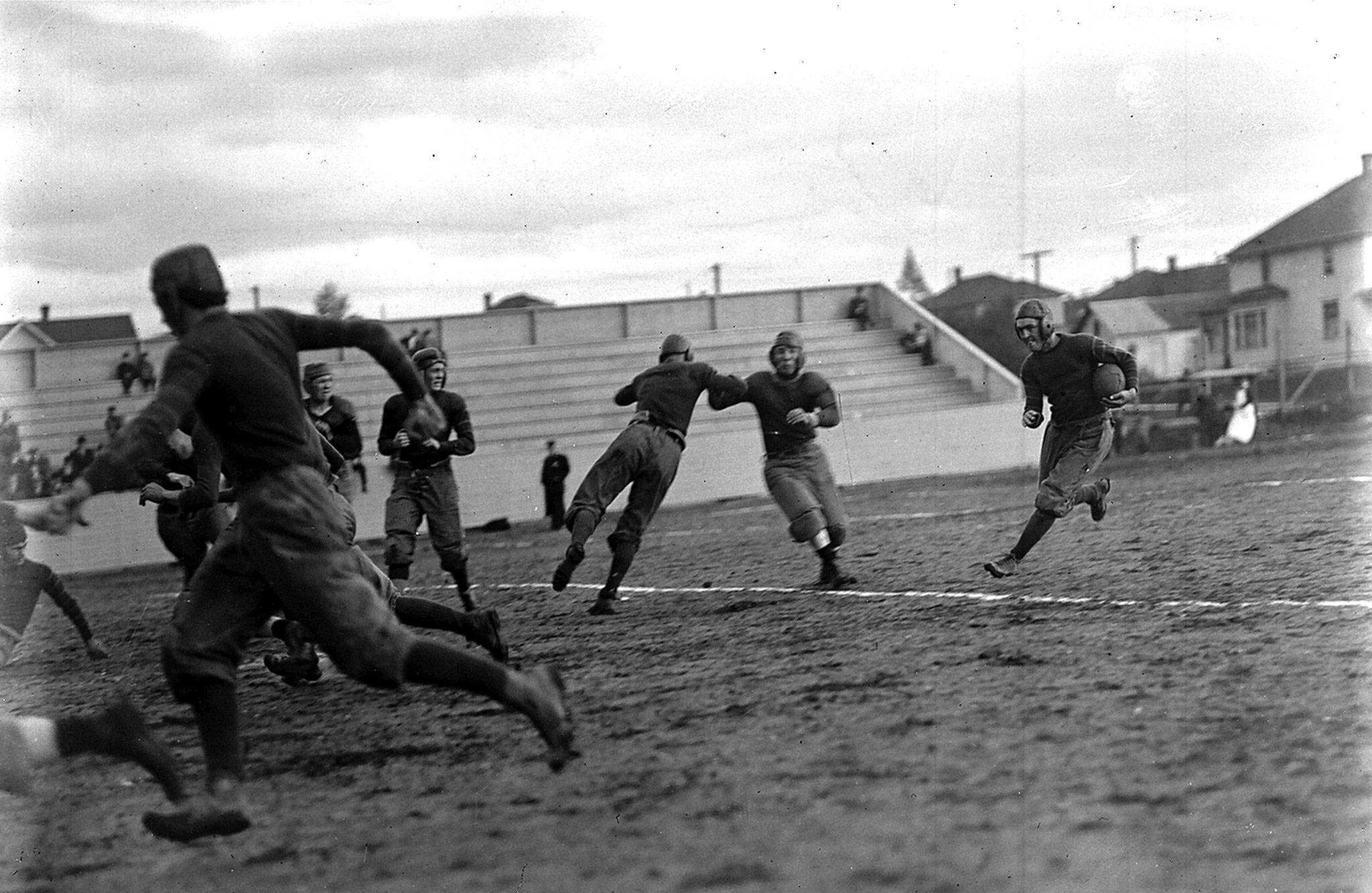This Oct. 4, 1913 photo shows the Everett High School team in a game against Bellingham at Athletic Park Field. Dan Michel is carrying the ball. (J. A. Juleen/Everett Public Library)