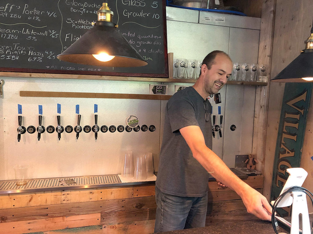 Cole Rinehardt behind the bar at the taproom at In The Shadow Brewing. (Aaron Swaney)
