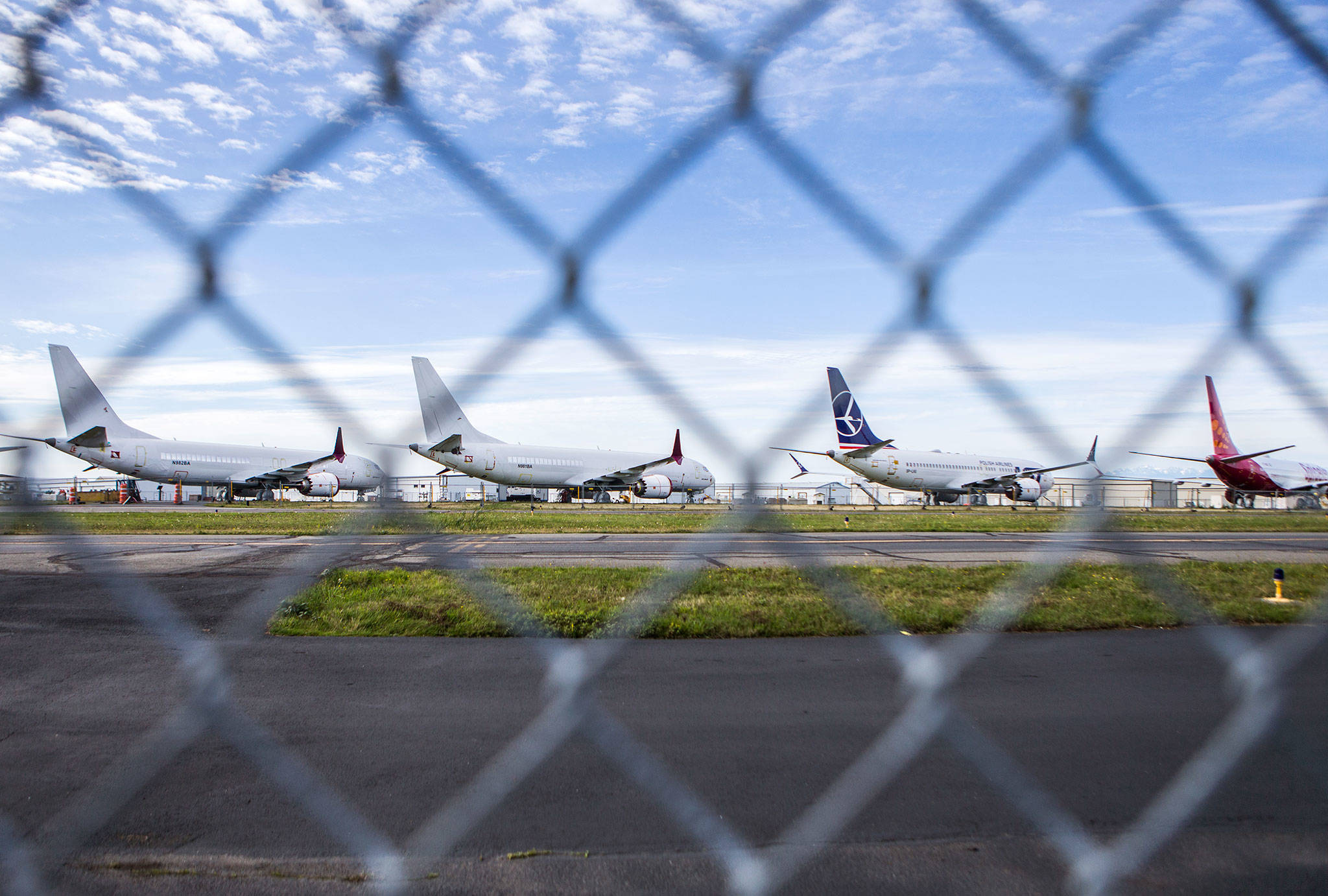 A handful of 737 Max planes sit along a runway at Paine Field on Wednesday in Everett. (Olivia Vanni / The Herald)