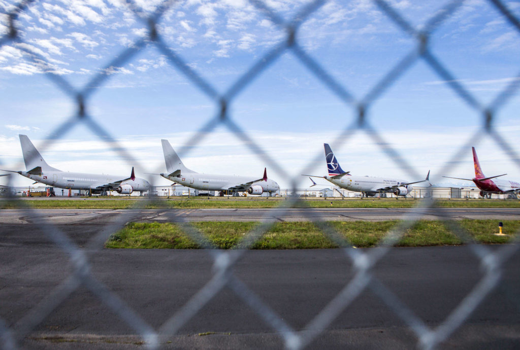A handful of 737 Max planes sit along a runway at Paine Field on Wednesday in Everett. (Olivia Vanni / The Herald)
