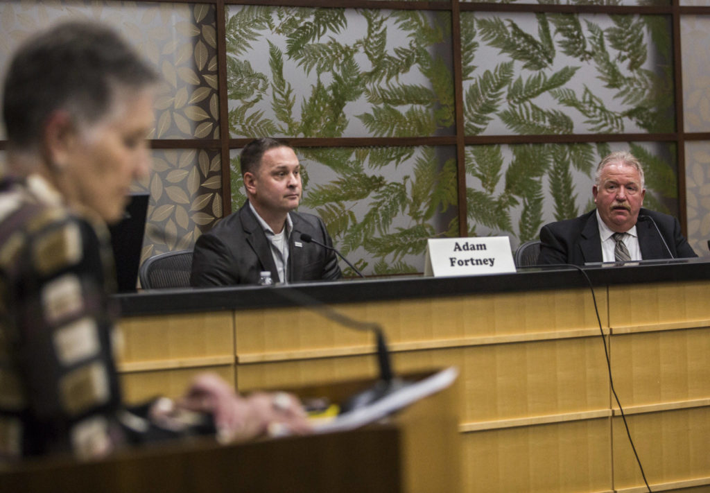 Snohomish County Sheriff Ty Trenary (right) and challenger Adam Fortney, a sergeant in the organization, speak Monday at a League of Women Voters candidate forum in Everett. (Olivia Vanni / The Herald)
