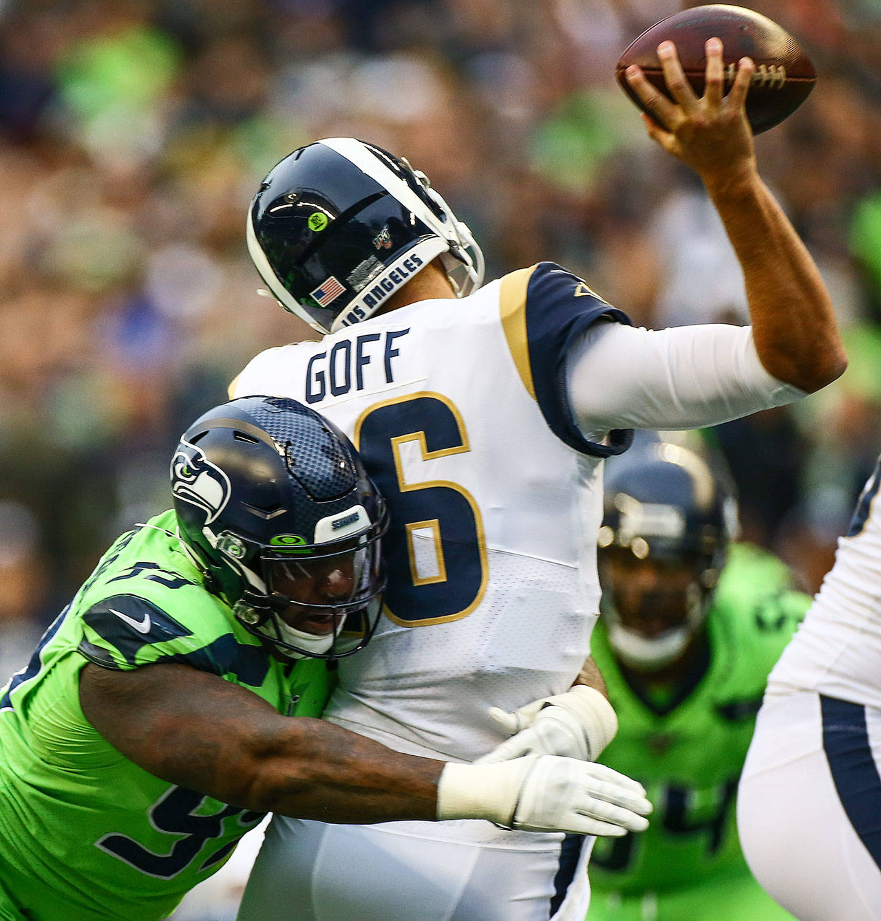 Seattle’s Quinton Jefferson (left) hits L.A. Rams quarterback Jared Goff as he attempts to throw a pass during the Seahawks’ 30-29 win over the Rams on Thursday at CenturyLink Field in Seattle.(Kevin Clark / The Herald)