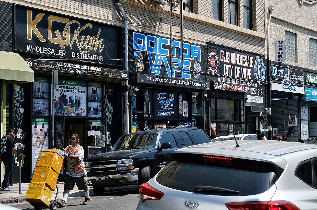 A bustling street is lined with wholesale vape shops in downtown Los Angeles this summer. (AP Photo/Richard Vogel, File)