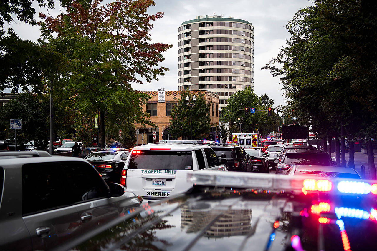 Local law enforcement vehicles line up along Washington Street in downtown Vancouver, Washington, as they work an active shooter situation at Smith Tower Apartments on Thursday. (Alisha Jucevic/The Columbian via AP)