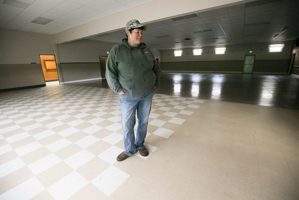 Silvana Community Association member Mary Fuentes talks about the new floor in Viking Hall. The group hopes to make more upgrades, but is running out of money. (Andy Bronson / The Herald)
