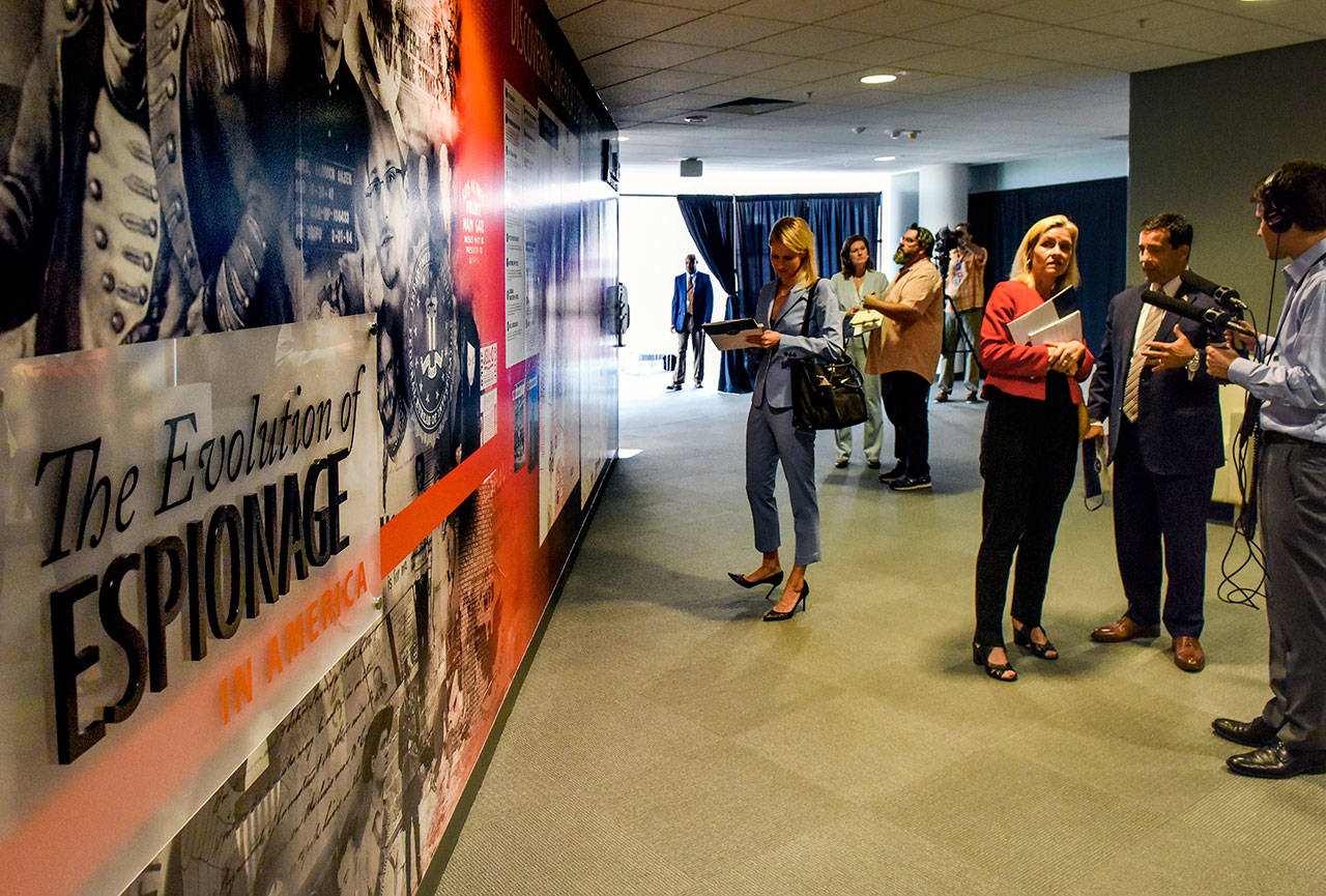 Reporters and officials take in the new “Wall of Spies Experience” as the National Counterintelligence and Security Center unveils its new museum. (Bill O’Leary/Washington Post)