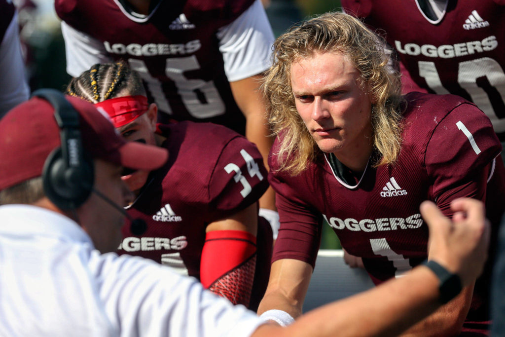 Murdock Rutledge (right), an Everett High School alumnus, is in his second season at quarterback for the University of Puget Sound. (Kevin Clark / The Herald) 
