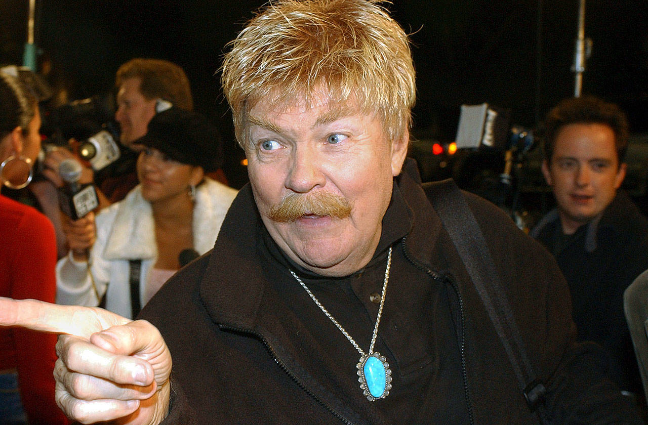 Comedian Rip Taylor talks with reporters before a film premiere in the Hollywood section of Los Angeles on Oct. 21, 2002. Taylor, the mustached comedian with a fondness for confetti-throwing who became a television game show mainstay in the 1970s, died Sunday. He was 88. (AP Photo/Rene Macura, File)