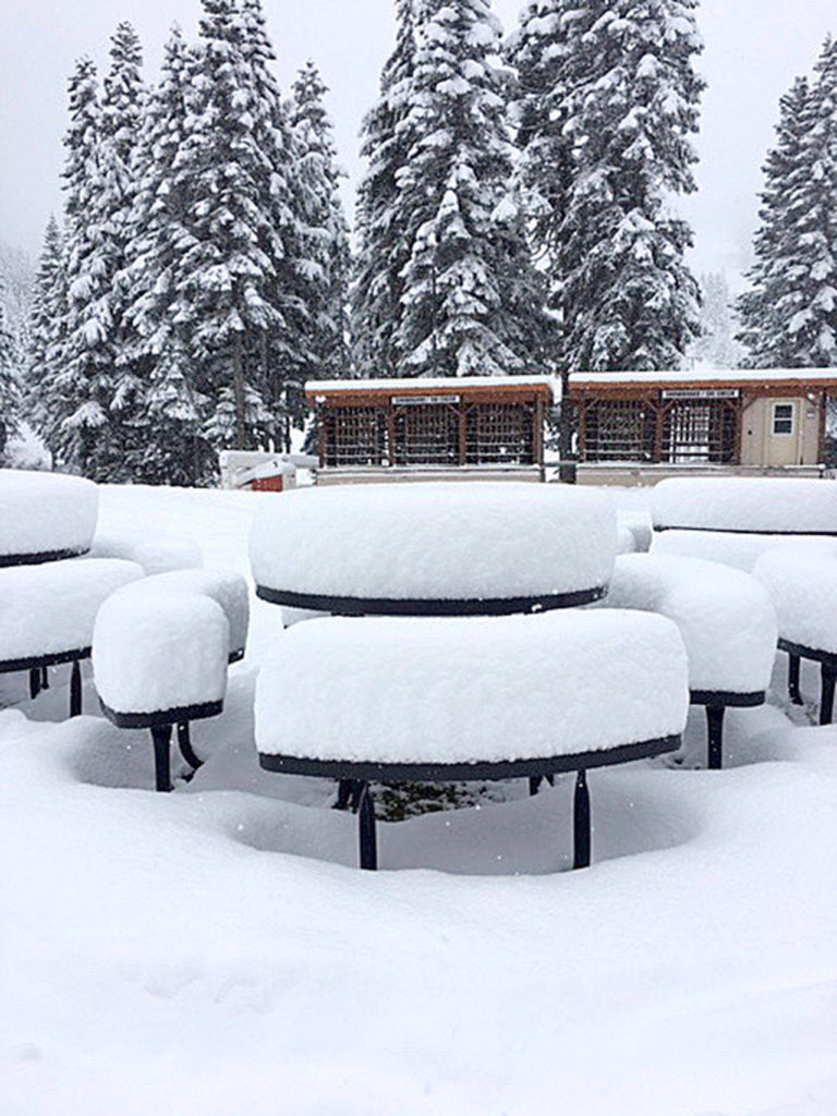 Snow stacked up on tables outside of the Stevens Pass ski resort on Tuesday. An estimated 10 inches fell in less than a day. (Stevens Pass)
