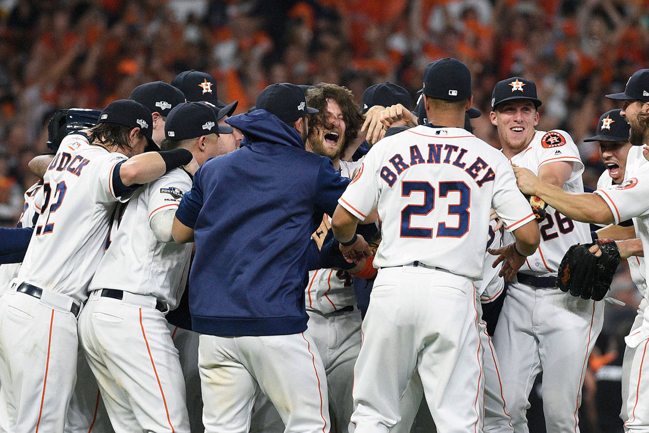 Astros starting pitcher Gerrit Cole (center) celebrates with teammates after beating the Rays in Game 5 of the American League Division Series on Oct. 10, 2019, in Houston. (AP Photo/Eric Christian Smith)