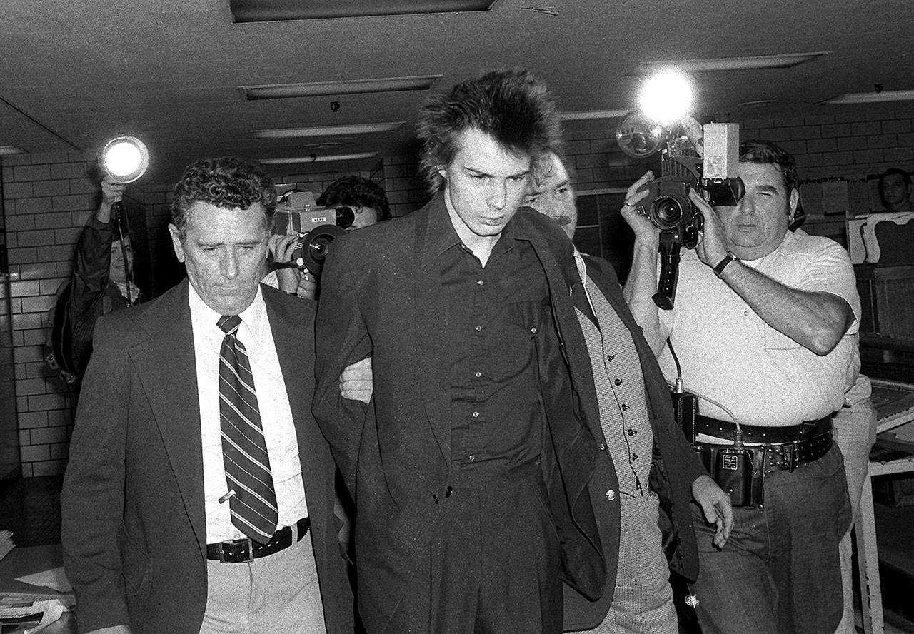 New York police escort British punk rocker Sid Vicious, formerly of the Sex Pistols, shortly before he was charged with murder in the stabbing death of his girlfriend, Nancy Laura Spungen, at New Yorks Chelsea Hotel, on Oct. 13, 1978. (Associated Press file)