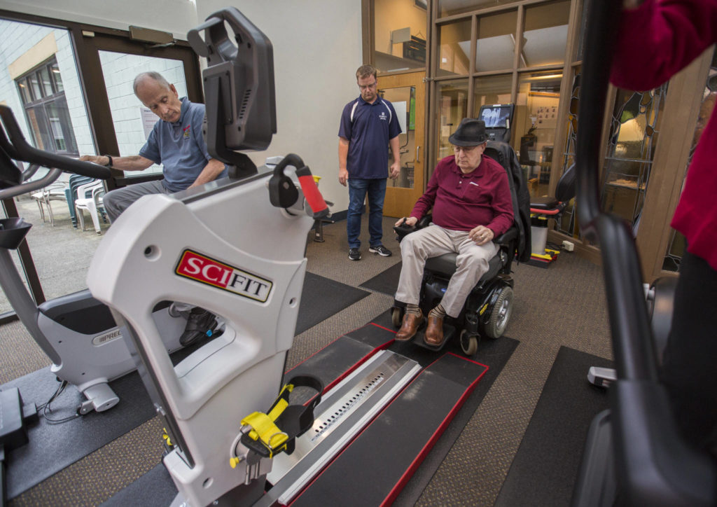 Ron Moran tests out the wheelchair accessible SCIFIT machine at the Carl Gipson Senior Center’s new fitness room. (Olivia Vanni / The Herald)
