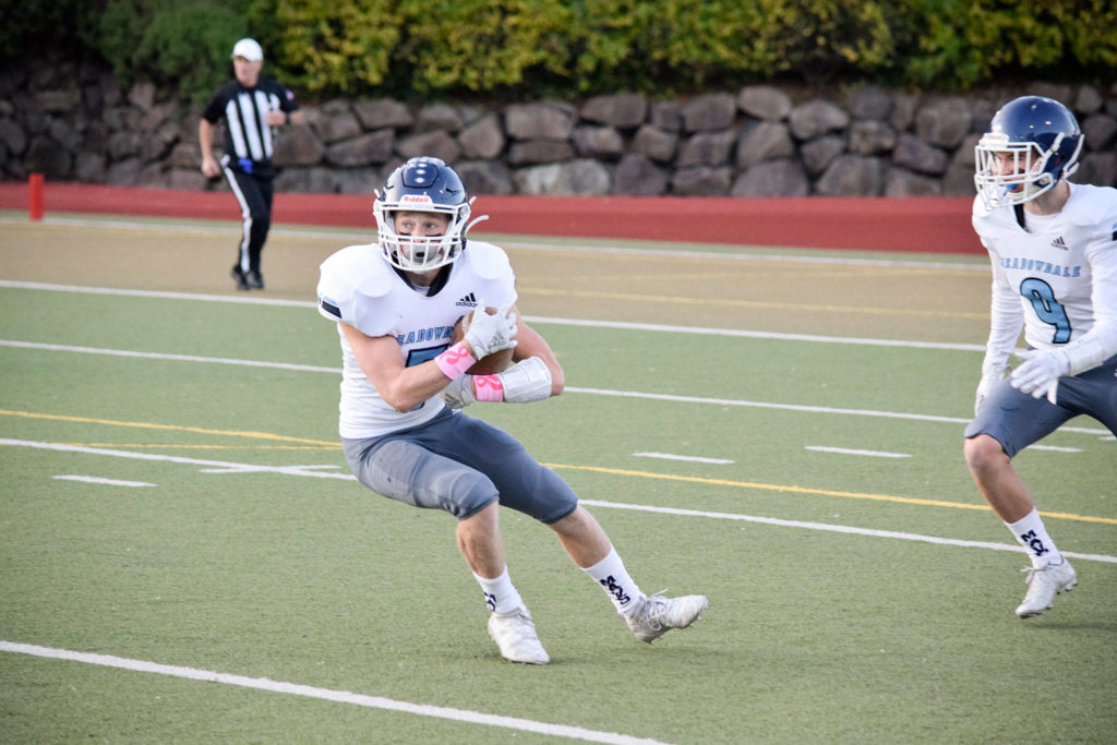 Senior running back Kristian Lunsford returns the ball for Meadowdale against Everett on Friday, Oct. 11 at Everett Memorial Stadium. (Katie Webber / The Herald)
