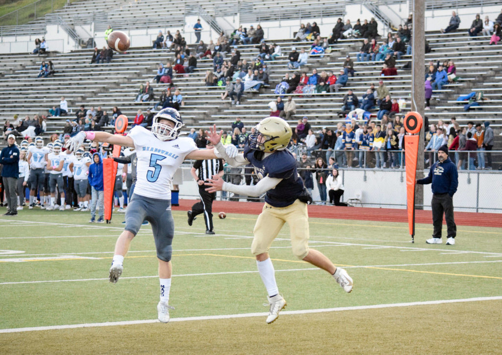 Senior defensive back Kristian Lunsford (left) breaks up a pass to junior wide receiver Cody Bennett (right) on Friday, Oct. 11 at Everett Memorial Stadium. (Katie Webber / The Herald)
