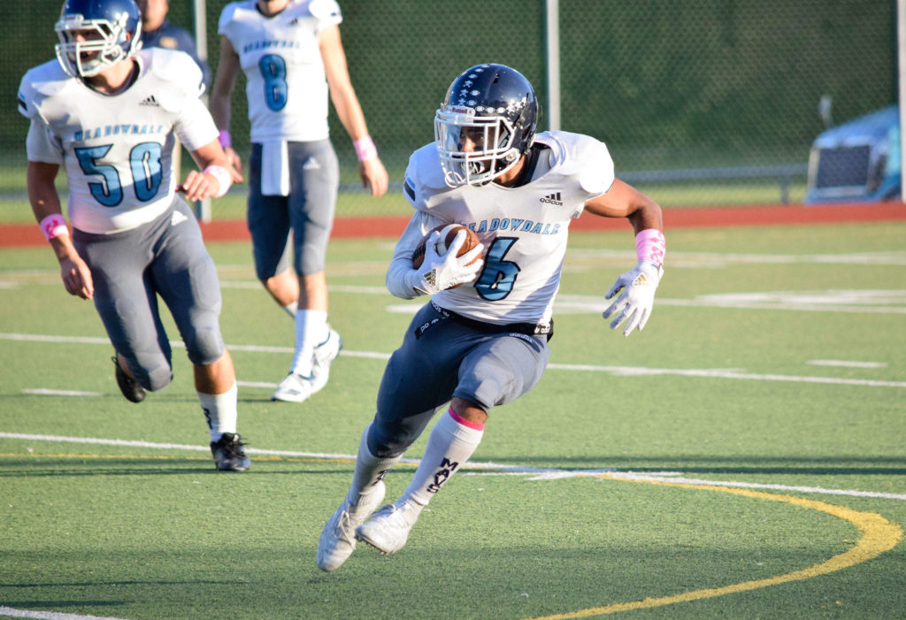 Senior running back Hussain Al-Mayyahi runs towards the sideline against Everett on Friday, Oct. 11 at Everett Memorial Stadium. (Katie Webber / The Herald)
