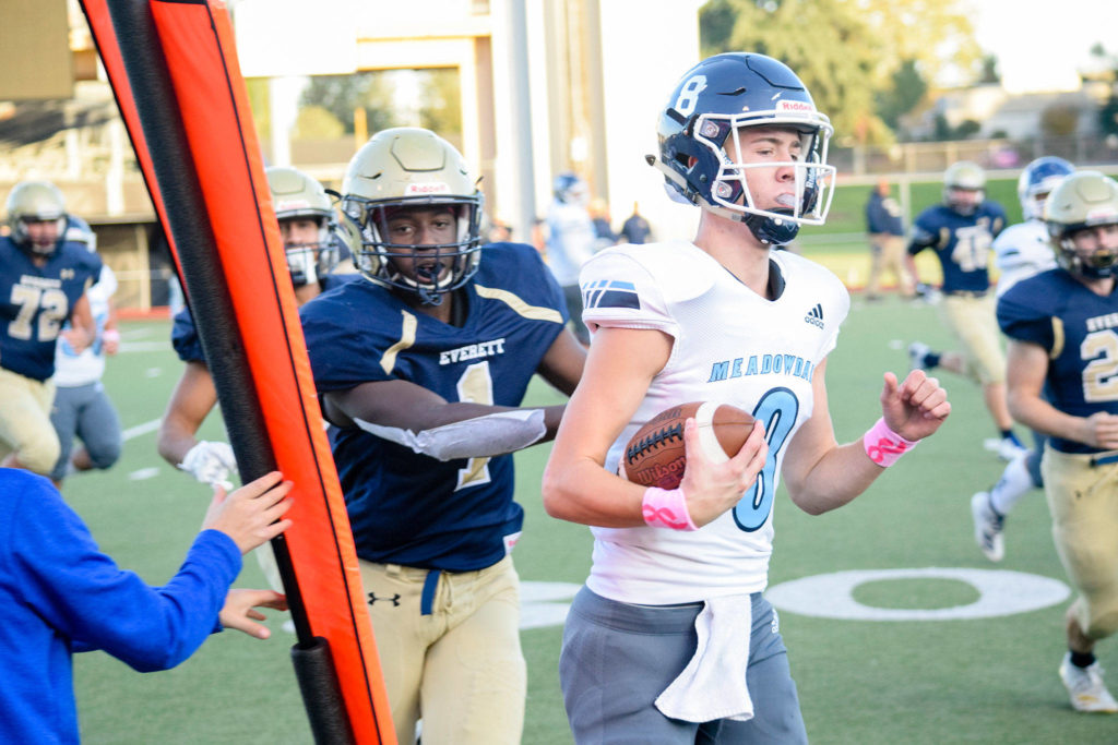 Senior quarterback Hunter Moen (right) is pushed out of bounds for a first down by Everett’s junior safety Jeremy Reed on Friday, Oct. 11 at Everett Memorial Stadium. (Katie Webber / The Herald)

