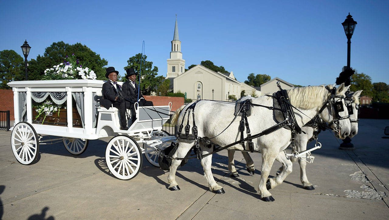 A horse-drawn hearse containing the body of opera star Jessye Norman leaves the William B. Bell Auditorium, site of her funeral, in Augusta, Georgia, on Saturday. (Michael Holahan/The Augusta Chronicle via AP)