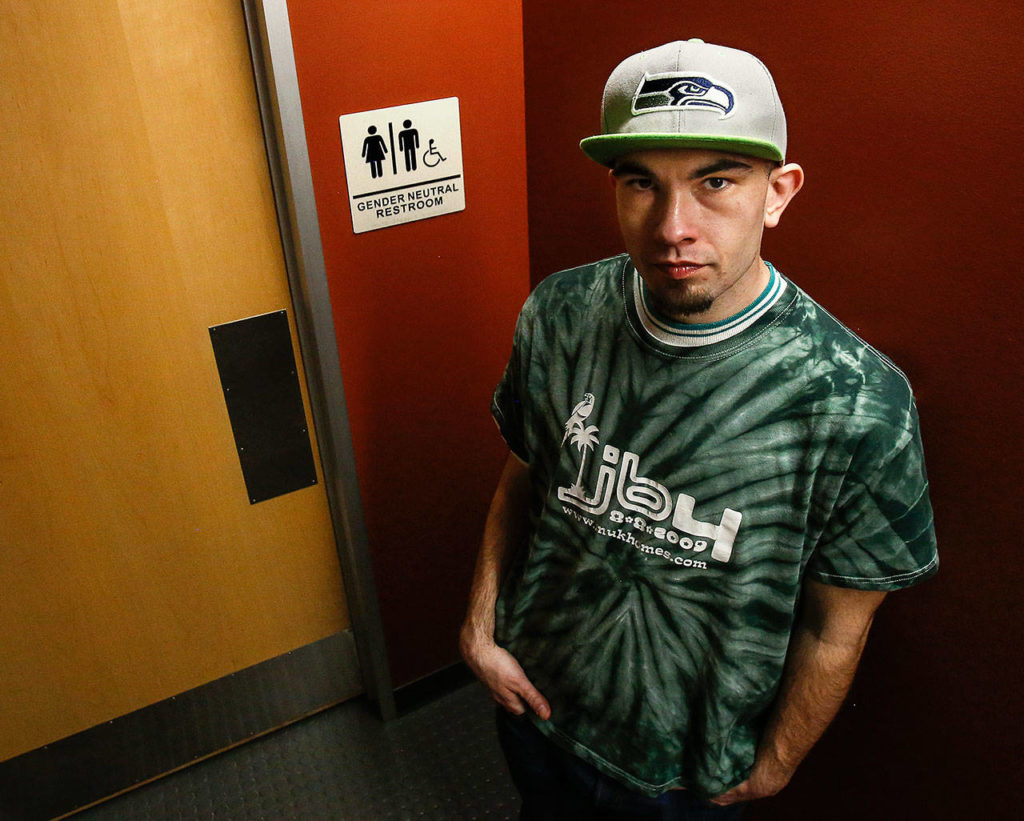 Colton Smith, 22, was among those who used one of two new gender-neutral restrooms in Snohomish County’s Robert J. Drewel Administration Building on Monday. (Dan Bates / The Herald) 
