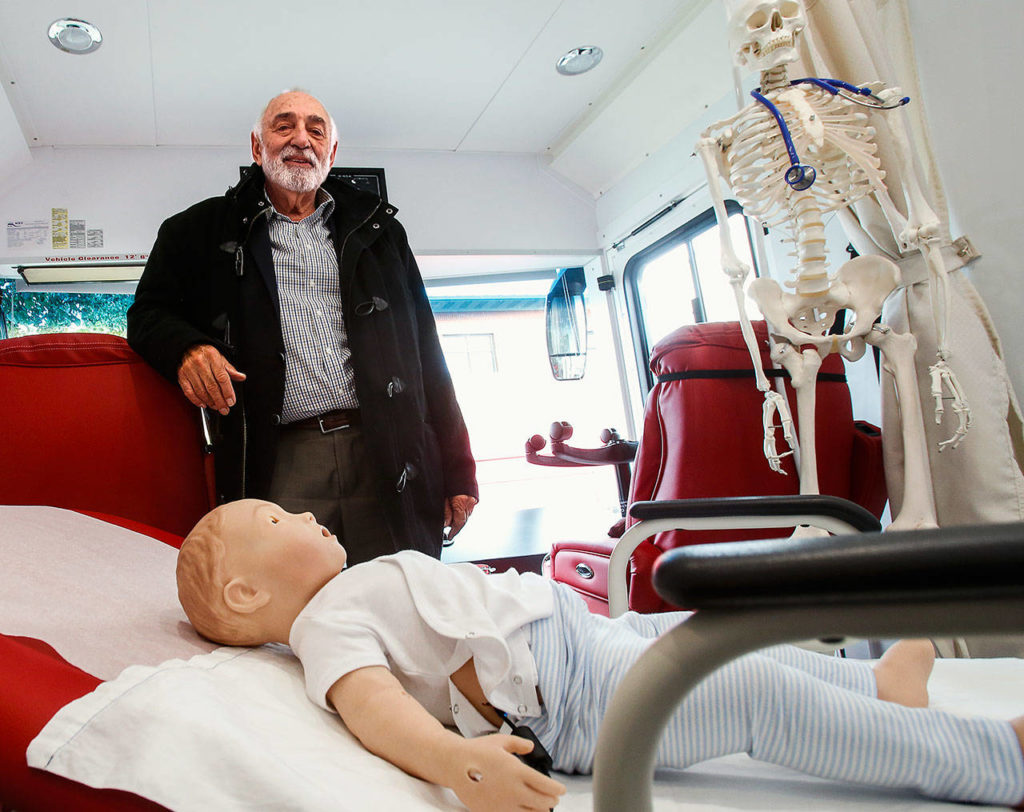 Dr. Larry Schecter, associate dean of clinical education-Everett with WSU’s Elson S. Floyd College of Medicine, shows off the new Range Health mobile medical unit in Everett on Thursday. It features two exam rooms, and high-fidelity mannequins used for simulated patient care. (Dan Bates / The Herald)
