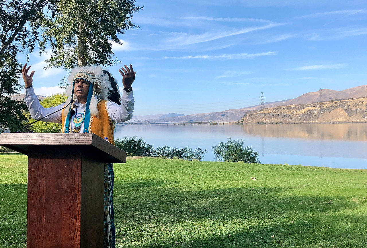 JoDe Goudy, chairman of the Yakama Nation, speaks with the Columbia River in the background near The Dalles, Oregon, on Monday where Celilo Falls, an ancient salmon fishing site, was destroyed by the construction of the Dalles Dam in the 1950s. (AP Photo/Gillian Flaccus)