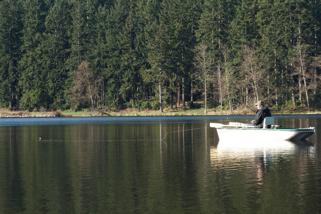 Dale Dennis of Arlington fishes a chironomid pupa pattern on Whidbey Island’s Lone Lake. (Mike Benbow photo)

