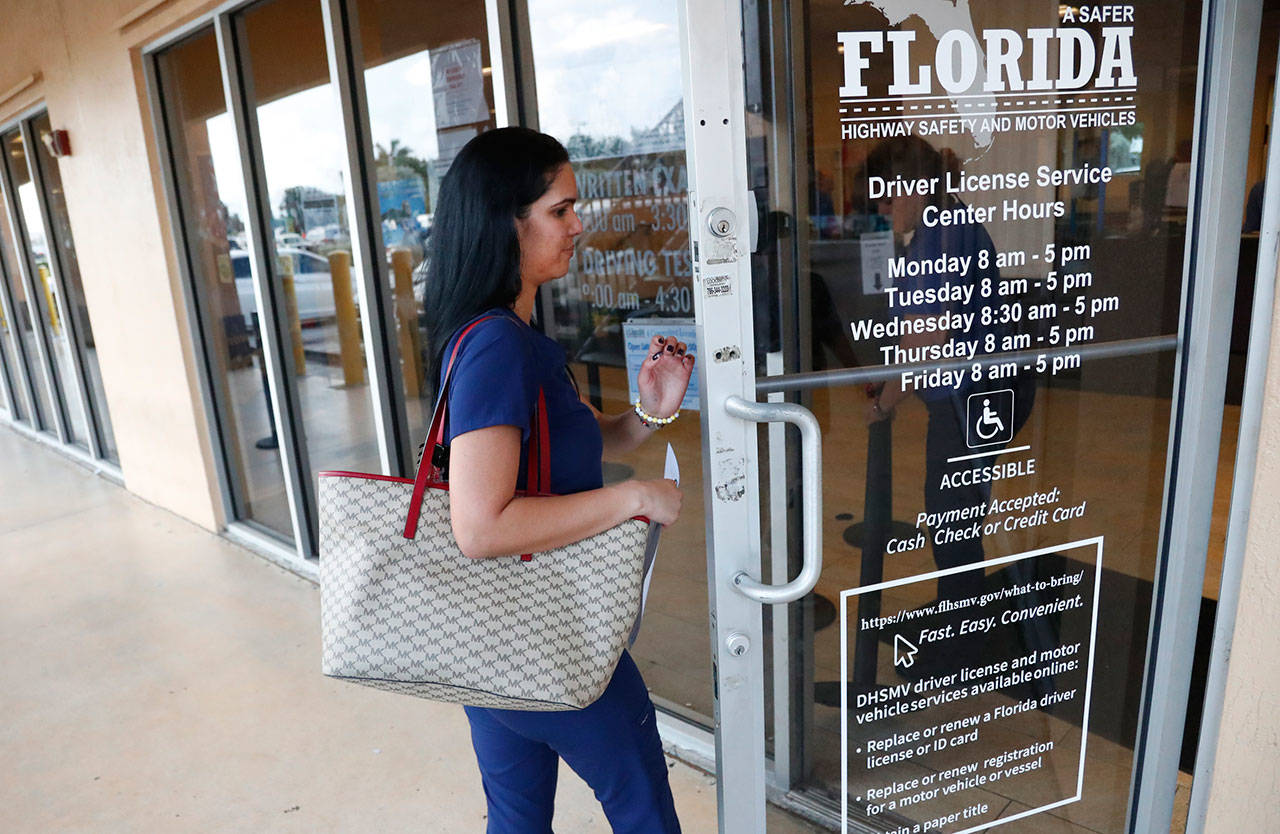 A woman enters a Florida Highway Safety and Motor Vehicles drivers license service center Oct. 8 in Hialeah, Florida. The U.S. Census Bureau has asked the 50 states for drivers’ license information, months after President Donald Trump ordered the collection of citizenship information. (AP Photo/Wilfredo Lee)