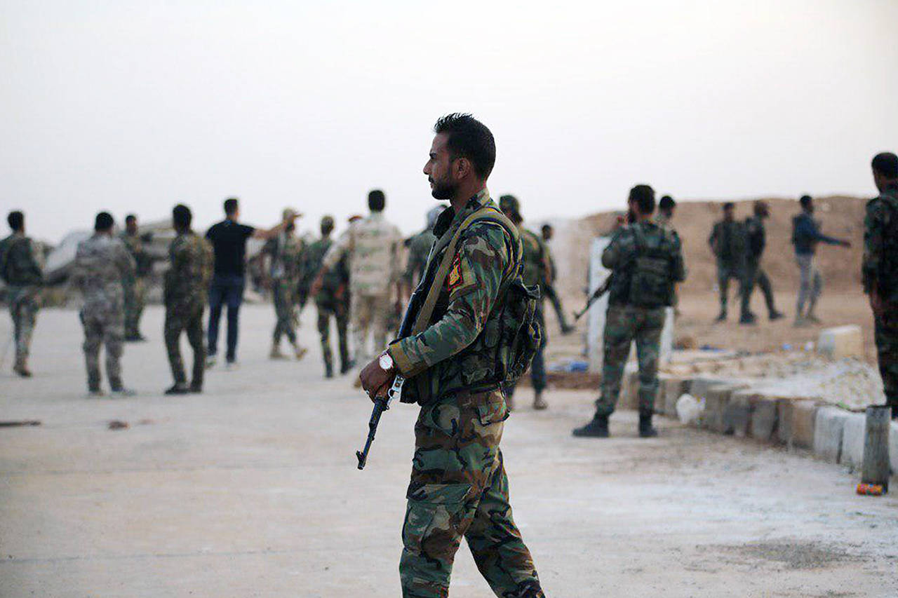 Syrian troops deploy in the Tabqa airbase in Raqqa, Syria on Monday. (SANA via AP)