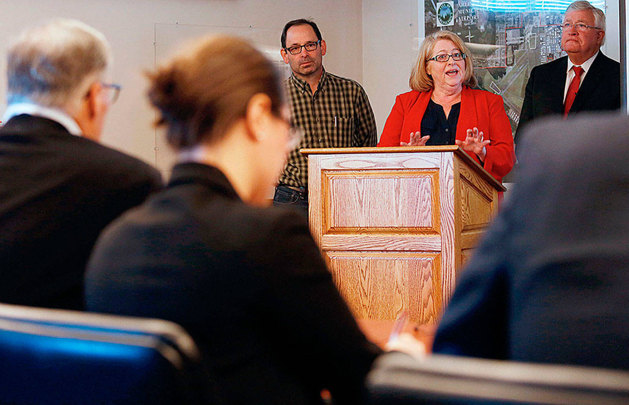 With two other judges, Gov. Jay Inslee (foregrond, left) listens to Arlington mayor Barbara Tolbert as she, Darrington Mayor Dan Rankin (left) and Bob Drewel practice their pitch for the America’s Best Communities competition at the Arlington Airport on April 7, 2016 in Arlingtoton. Arlington and Darrington were named as a finalist but did not finish in competition’s top three. (Andy Bronson / Herald file photo)