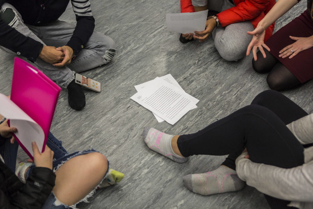 Students gather in a circle to talk about their essays they presented to their groups during class. (Olivia Vanni / The Herald)
