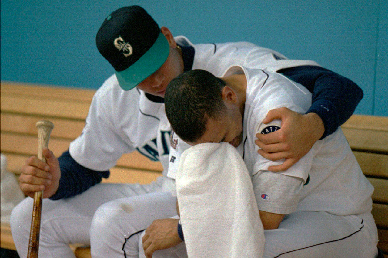 Alex Rodriguez (left) comforts teammate Joey Cora after the Mariners were eliminated bu the Indians in the American League Championship Series on Oct. 17, 1995, in Seattle. (AP Photo/Jack Smith)